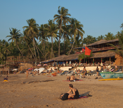 Visit Anjuna Beach with our Goa sightseeing taxi for a mix of beach fun and flea market shopping